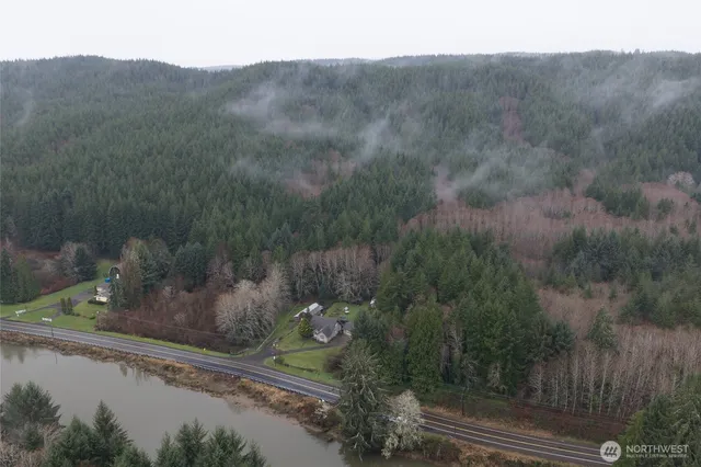 a view of a wooden house with a yard