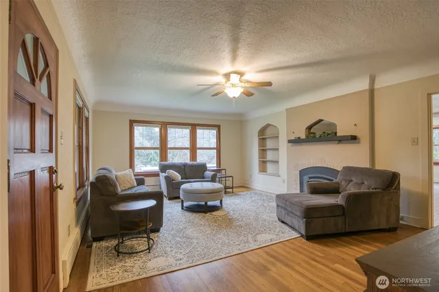 a living room with furniture and a chandelier