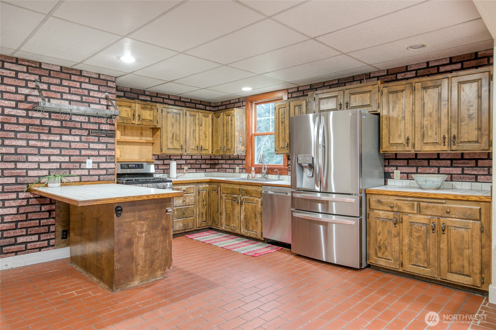 3321 Wishkah Road Aberdeen, WA 98520 - Photo 7 of 40 a kitchen with stainless steel appliances granite countertop a stove a sink dishwasher a refrigerator and white cabinets with wooden floor