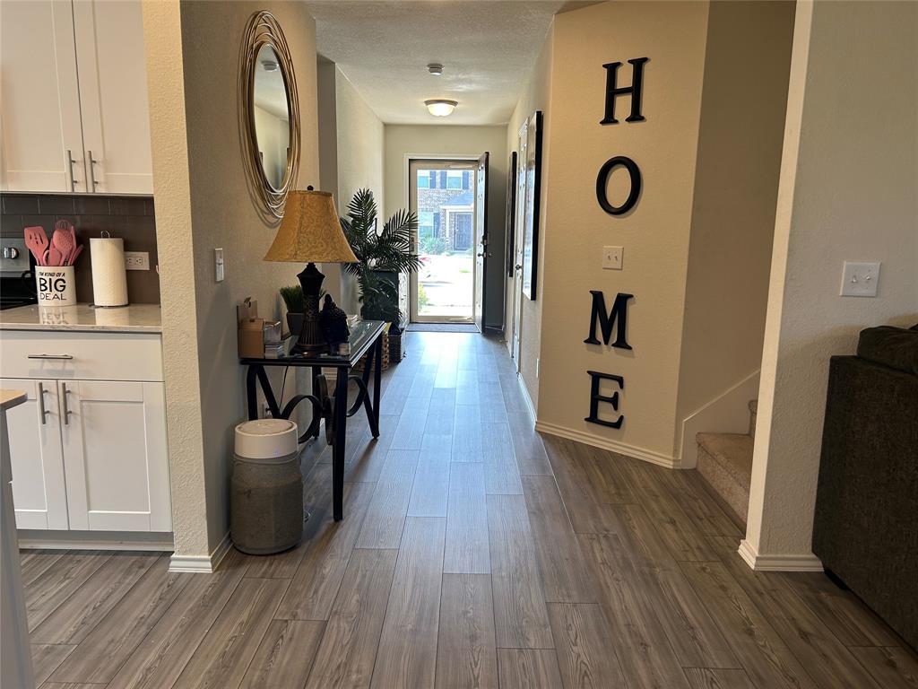 10109 Wyseby Road Crowley, TX 76036 - Photo 1 of 25 a view of a hallway with wooden floor and a bathroom