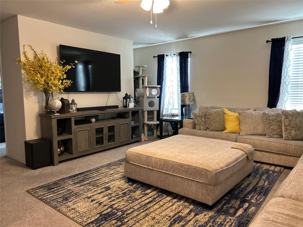 10109 Wyseby Road Crowley, TX 76036 - Photo 13 of 25 a spacious bedroom with a bed and a flat screen television