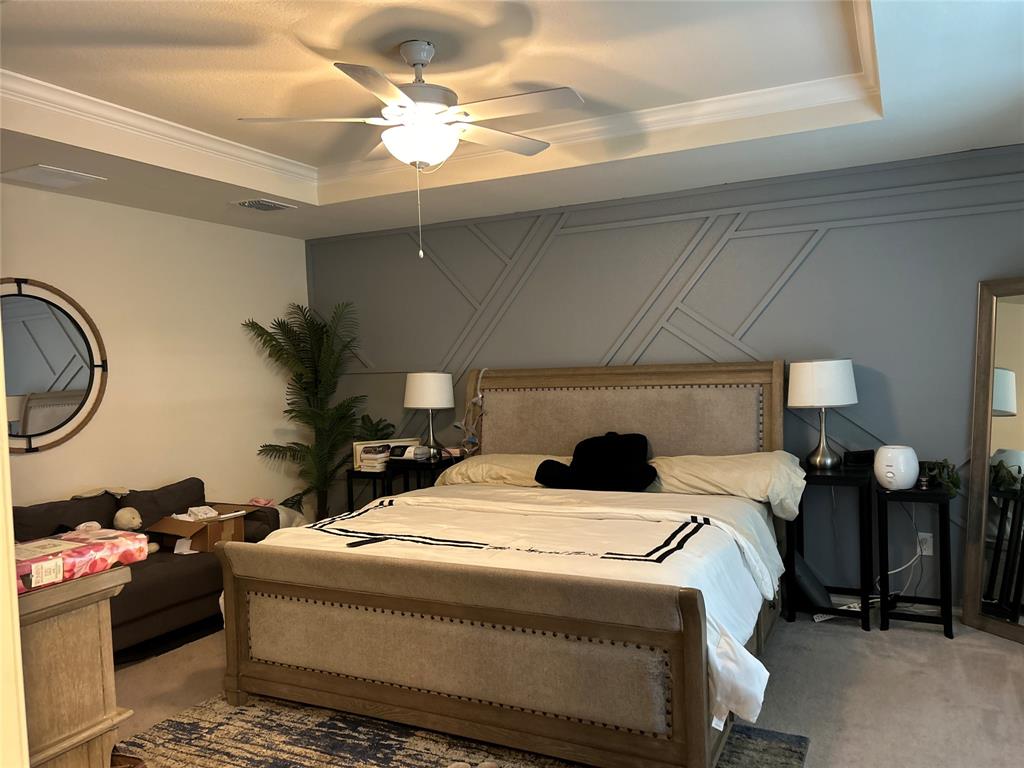 10109 Wyseby Road Crowley, TX 76036 - Photo 16 of 25 a bed room with a bed and a chandelier