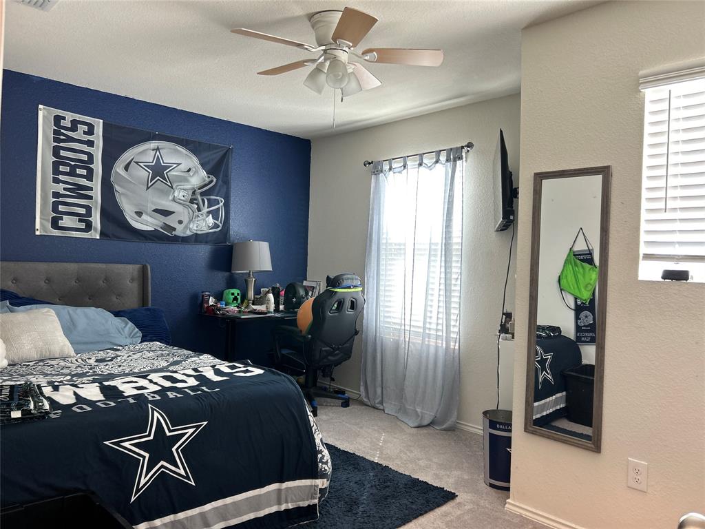 10109 Wyseby Road Crowley, TX 76036 - Photo 17 of 25 a bedroom with a bed and a chandelier