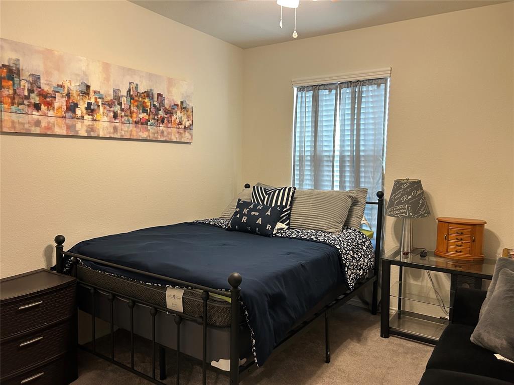 10109 Wyseby Road Crowley, TX 76036 - Photo 18 of 25 a bedroom with a bed and wooden floor