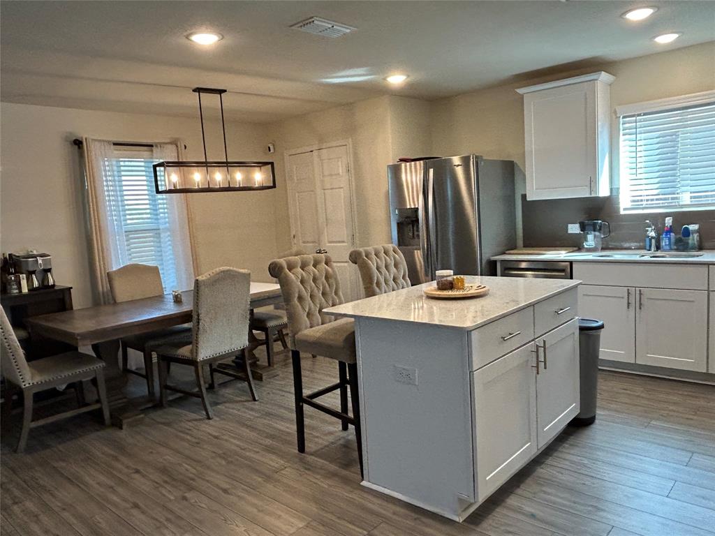 10109 Wyseby Road Crowley, TX 76036 - Photo 8 of 25 a kitchen with a center island appliances wooden floor and a window