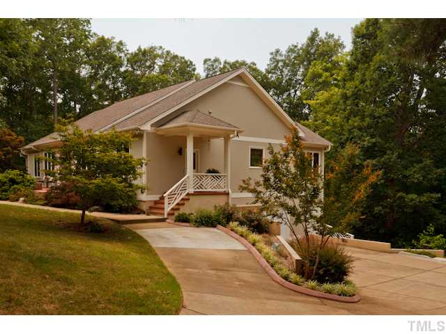7716 Senter Farm Road Apex, NC 27539 - Photo 12 of 25 Side view of the home, showing the attached 2-car garage and parking pad. You'll love the convenience of the secondary side porch entry.