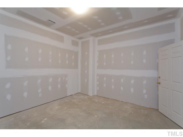 7716 Senter Farm Road Apex, NC 27539 - Photo 13 of 25 A bedroom in the partially finished basement. The heated basement measures 2387 square feet, and includes a fourth full bathroom.