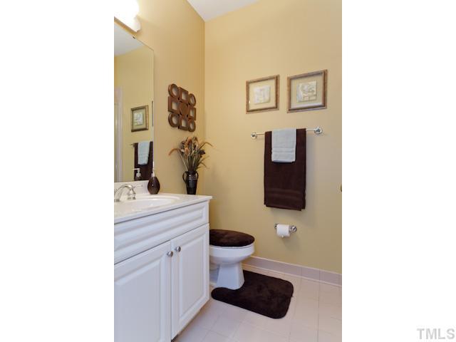 7716 Senter Farm Road Apex, NC 27539 - Photo 21 of 25 This attractive full bathroom with a shower is located off the main hallway of the home.