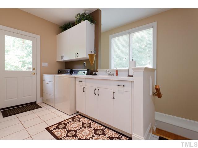 7716 Senter Farm Road Apex, NC 27539 - Photo 22 of 25 When entering through the side porch door, you'll come to this convenient utility room. Stairs lead to the basement below.