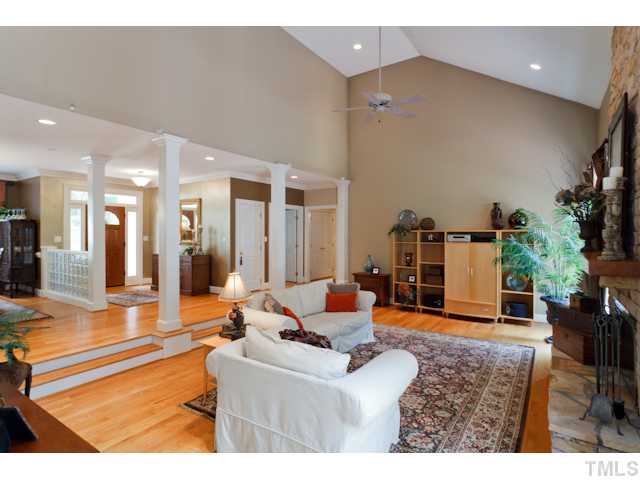 7716 Senter Farm Road Apex, NC 27539 - Photo 25 of 25 The sunken living room in this open floor plan features gleaming hardwood floors and unique fabric covered walls.