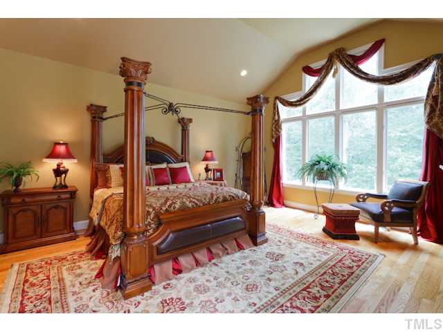 7716 Senter Farm Road Apex, NC 27539 - Photo 5 of 25 The plush master bedroom is bright and airy due to the numerous windows, covered with custom Silhouette shades. French doors lead to a private deck outside.