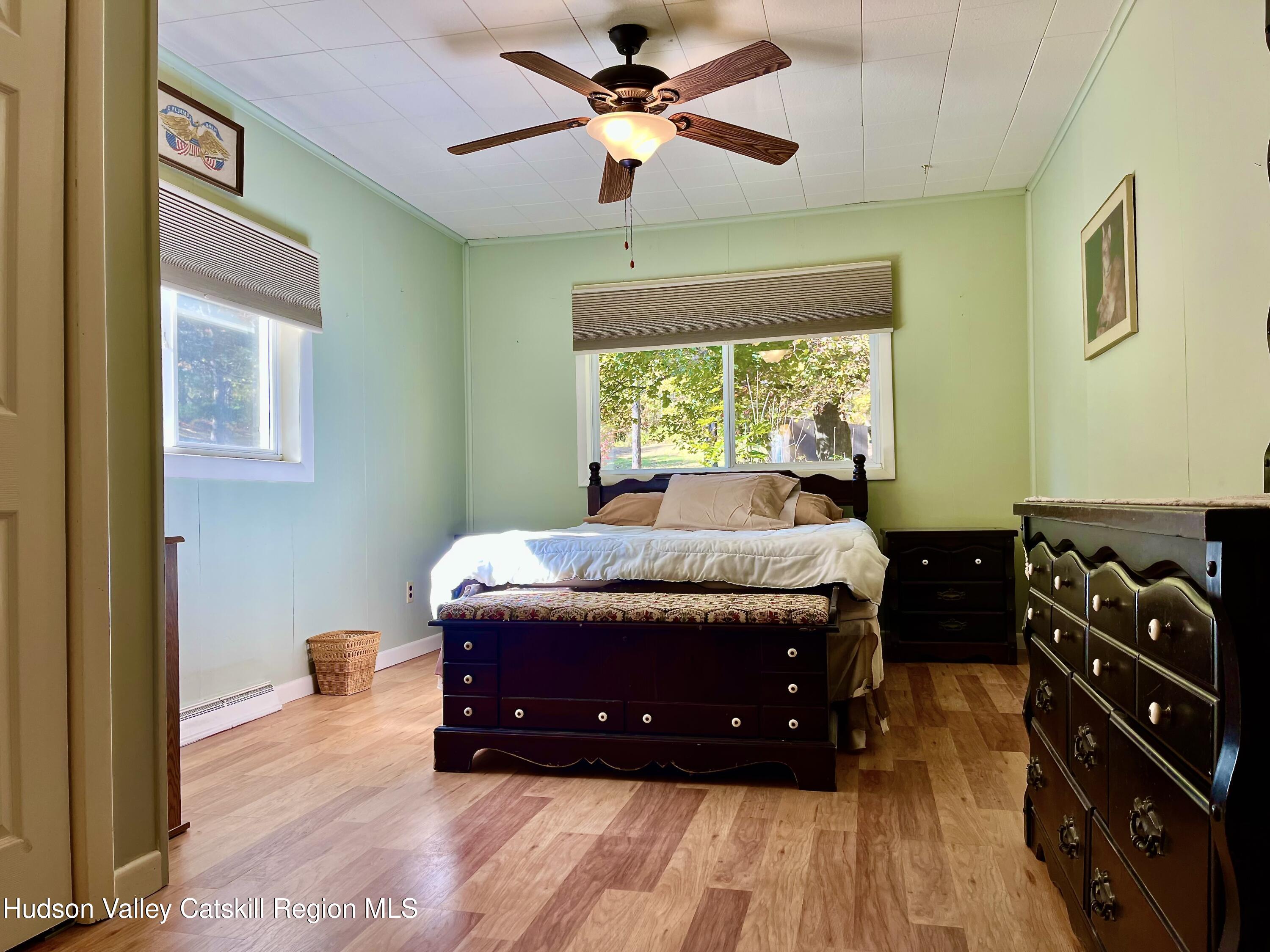 59 New Forge Rd I Ancram, NY 12502 - Photo 26 of 32 a bedroom with a bed and a chandelier