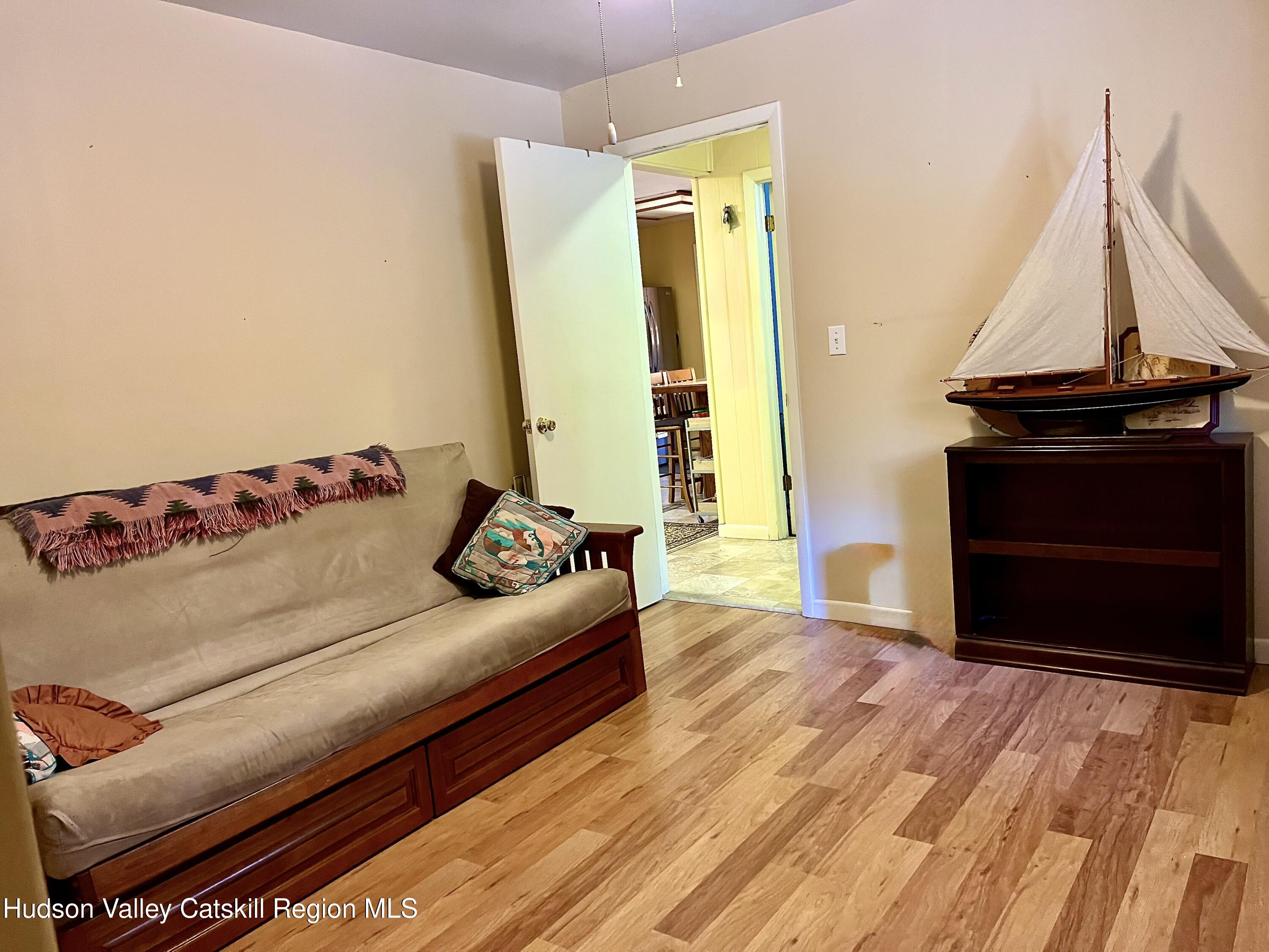 59 New Forge Rd I Ancram, NY 12502 - Photo 32 of 32 a living room with a couch and a wooden floor