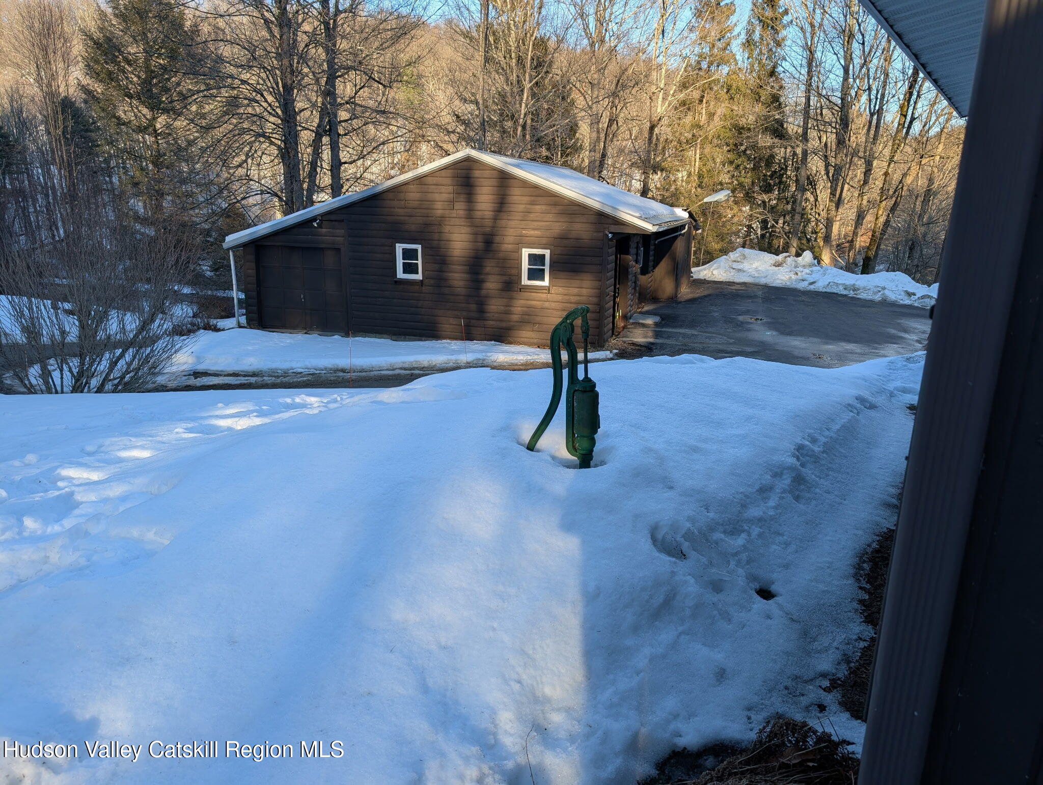 59 New Forge Rd I Ancram, NY 12502 - Photo 9 of 32 a small pool with a bench in the background