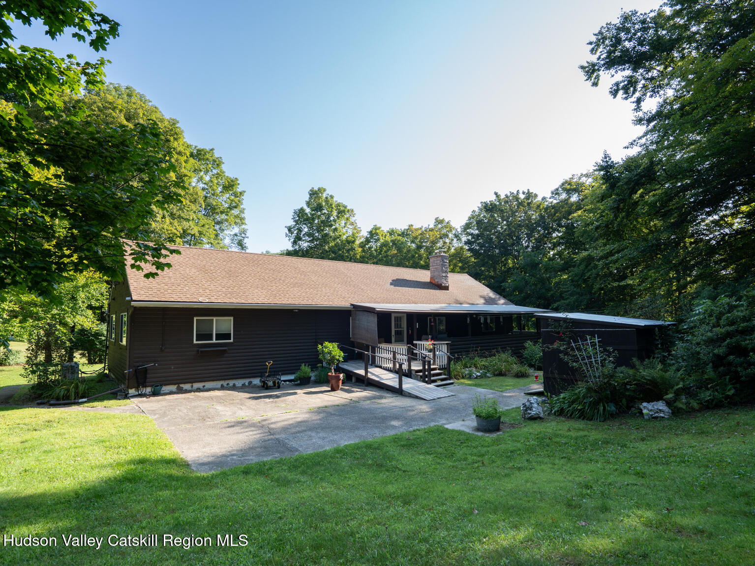 59 New Forge Rd I Ancram, NY 12502 - Photo 10 of 32 a view of a patio with table and chairs under an umbrella