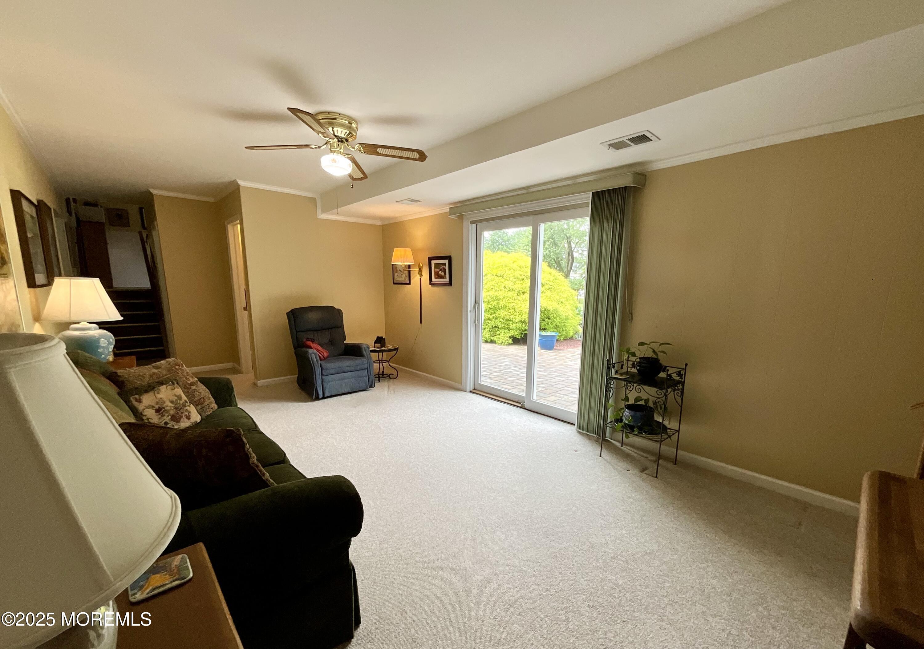 24 Homestead Road Freehold, NJ 07728 - Photo 29 of 39 a living room with furniture and a chandelier