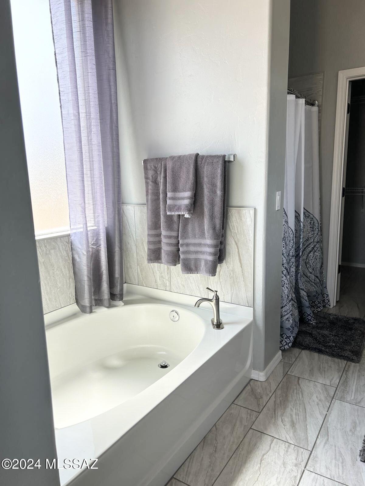 195 Ver Patria Rio Rico, AZ 85648 - Photo 9 of 17 a bathroom with bathtub and a shower
