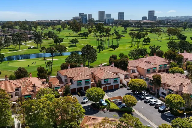 an aerial view of multiple houses with yard