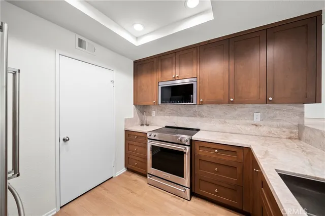 a kitchen with a refrigerator and a sink