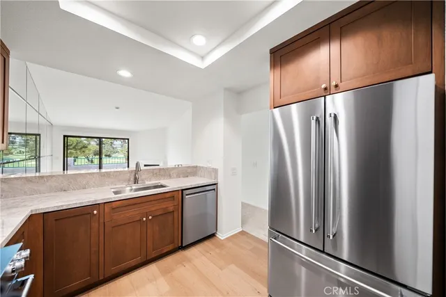 a view of a big room with windows and chandelier