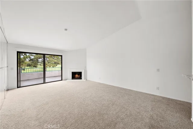 a view of empty room with ceiling fan and window