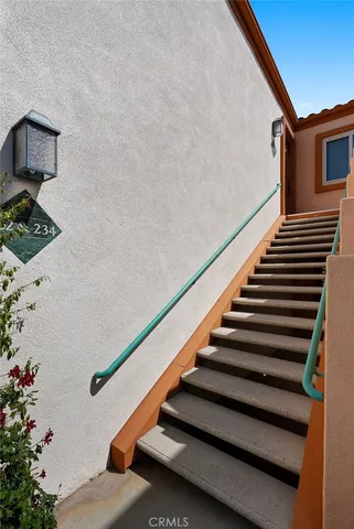a view of hallway with wooden floor and stairs