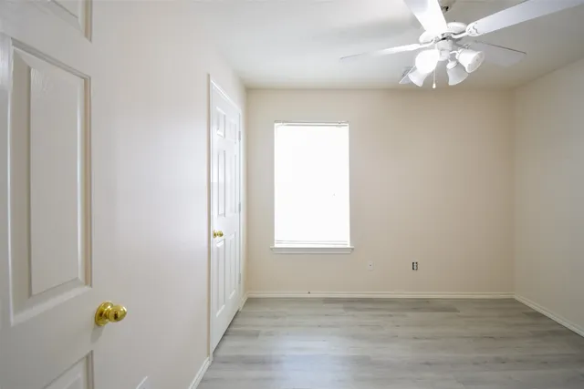wooden floor in an empty room with a window