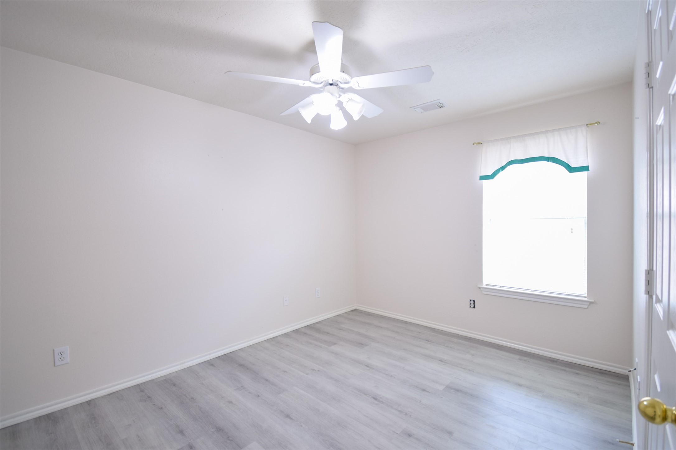 21315 Pepperberry Trail Spring, TX 77388 - Photo 15 of 21 an empty room with a window and a chandelier fan