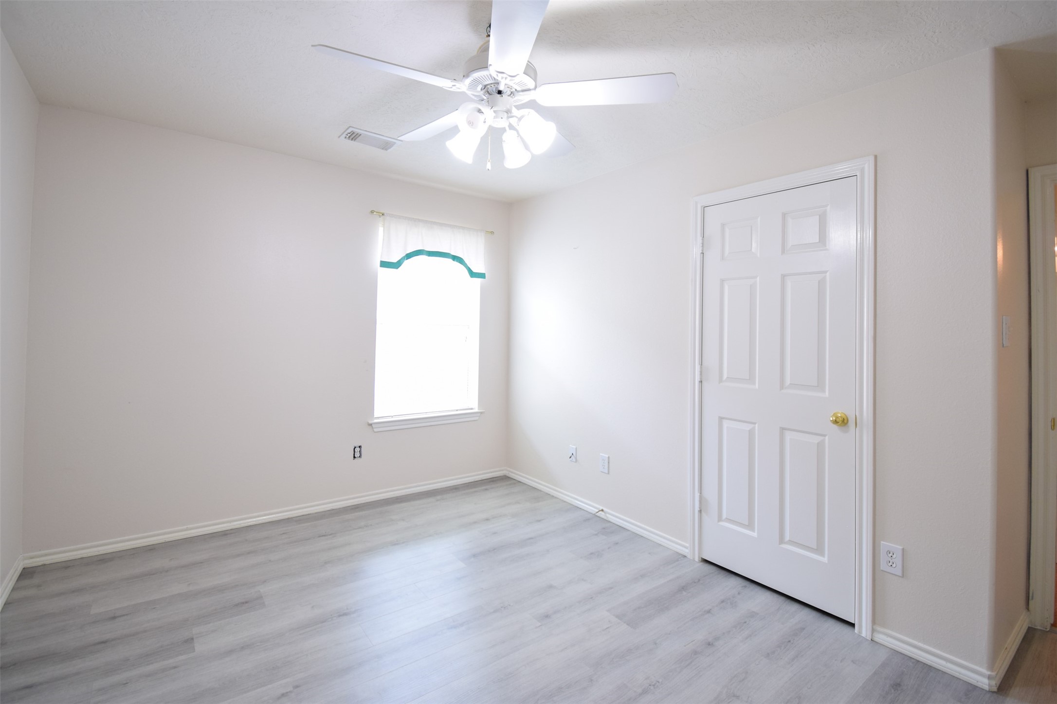 21315 Pepperberry Trail Spring, TX 77388 - Photo 17 of 21 an empty room with wooden floor and windows