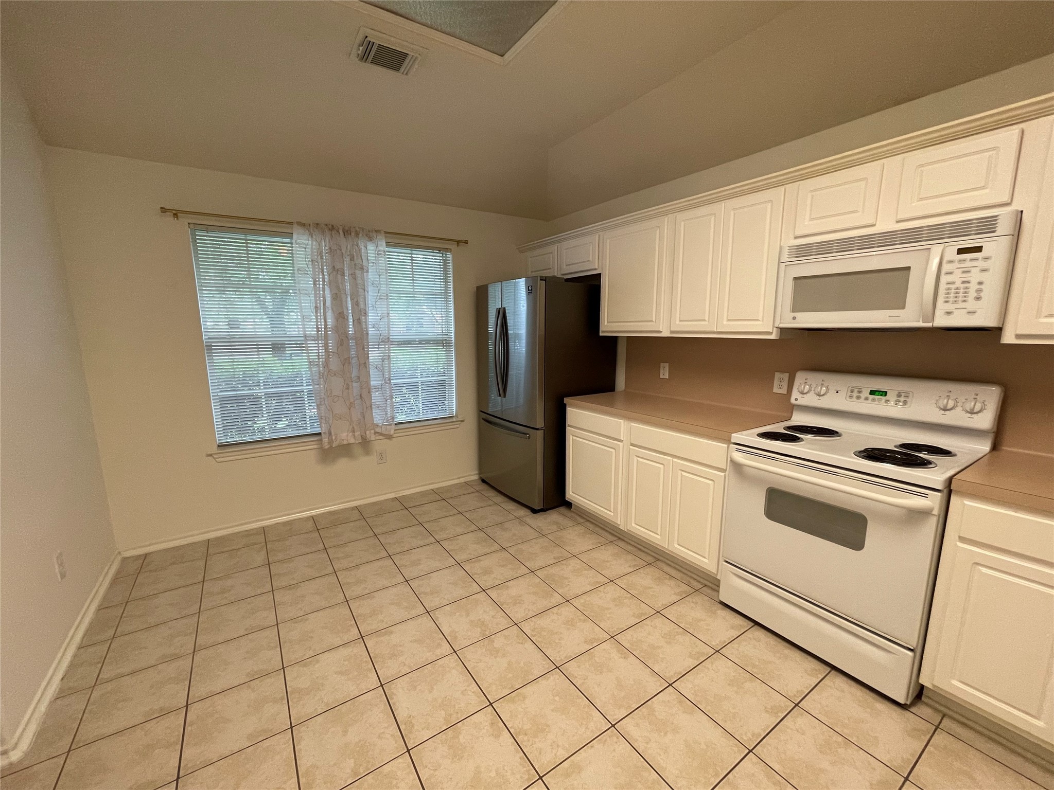 21315 Pepperberry Trail Spring, TX 77388 - Photo 6 of 21 a kitchen with a stove a sink and a refrigerator