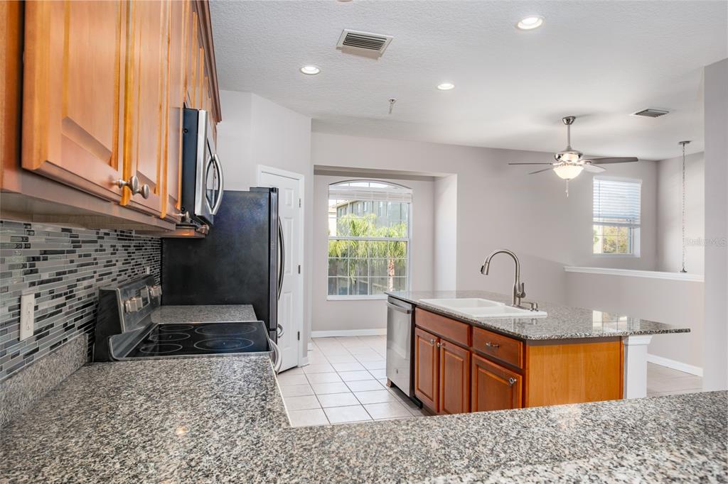 10220 Bayou Grande Seminole, FL 33772 - Photo 18 of 50 a bathroom with a granite countertop sink a mirror and shower