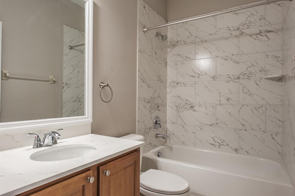 10220 Bayou Grande Seminole, FL 33772 - Photo 38 of 50 a bathroom with a granite countertop sink toilet and shower