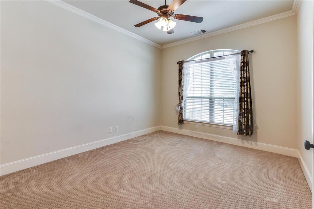 419 Rio Grande Drive Irving, TX 75039 - Photo 4 of 29 Arched window with blinds and decorative curtain rods, accompanied by a ceiling fan with integrated lighting