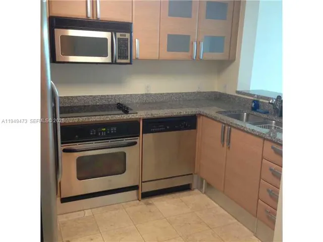 a kitchen with a stove and a microwave