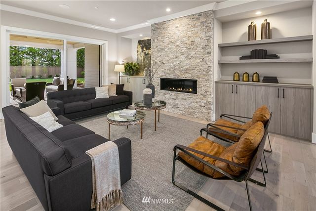 a living room with furniture fireplace and a large window