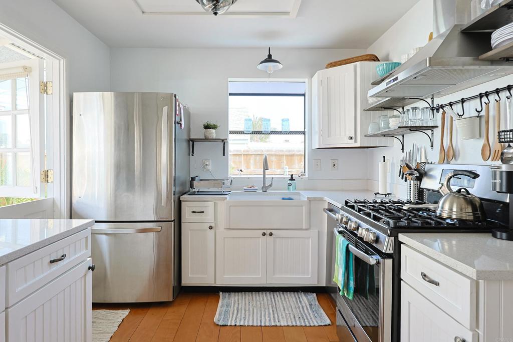 417 5th Street Coronado, CA 92118 - Photo 11 of 46 a kitchen with a refrigerator a sink and a stove