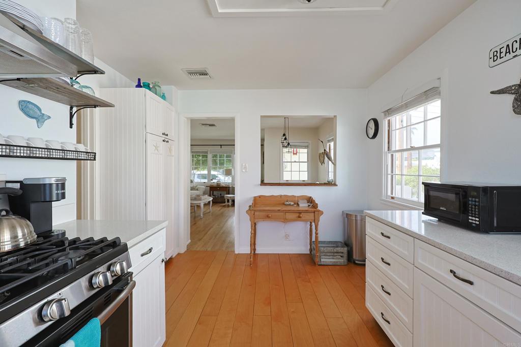 417 5th Street Coronado, CA 92118 - Photo 14 of 46 a kitchen with stainless steel appliances granite countertop a stove and a refrigerator