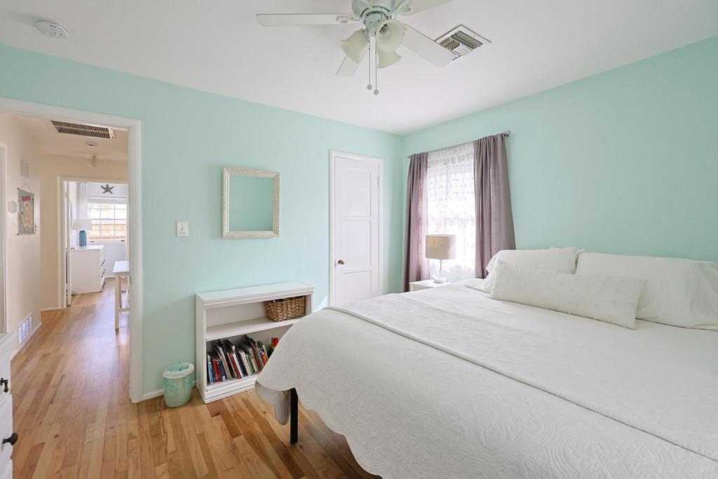 417 5th Street Coronado, CA 92118 - Photo 17 of 46 a bedroom with a bed and a chandelier