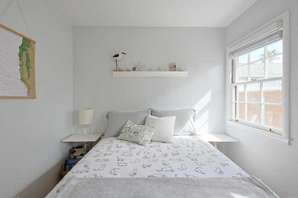 417 5th Street Coronado, CA 92118 - Photo 20 of 46 a bedroom with a bed and window