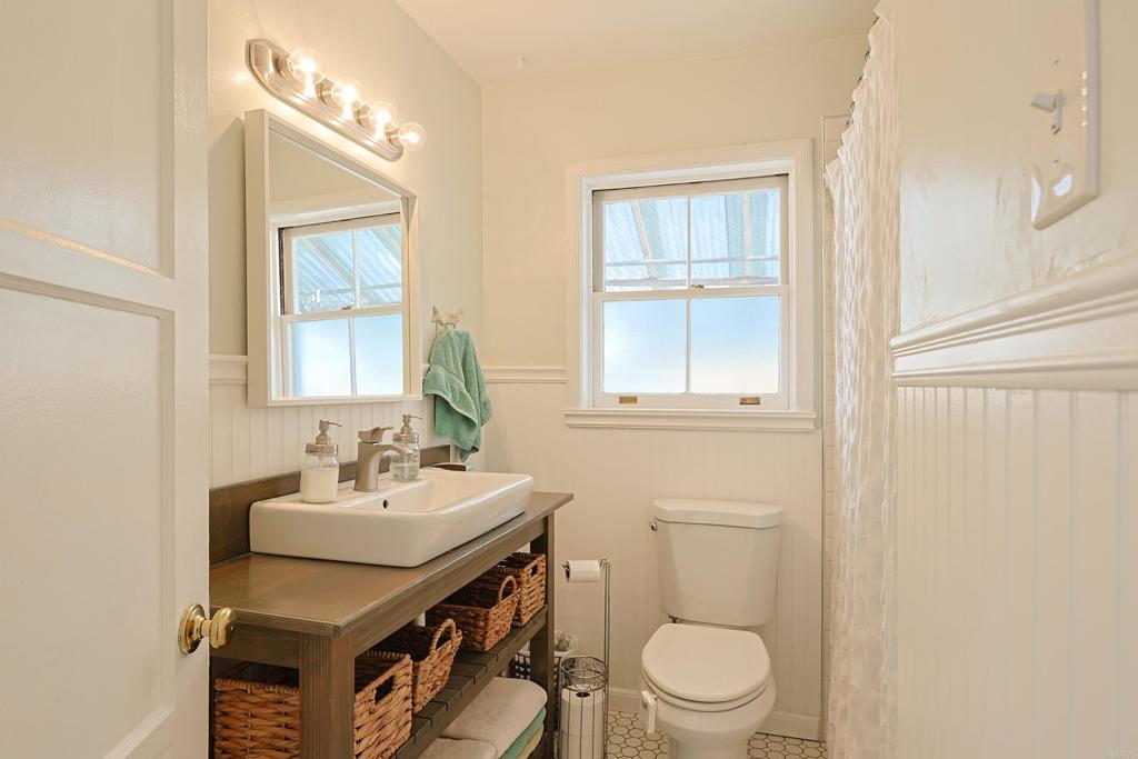417 5th Street Coronado, CA 92118 - Photo 24 of 46 a bathroom with a sink a toilet and a mirror