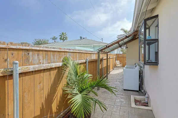 a view of a balcony with wooden floor and door