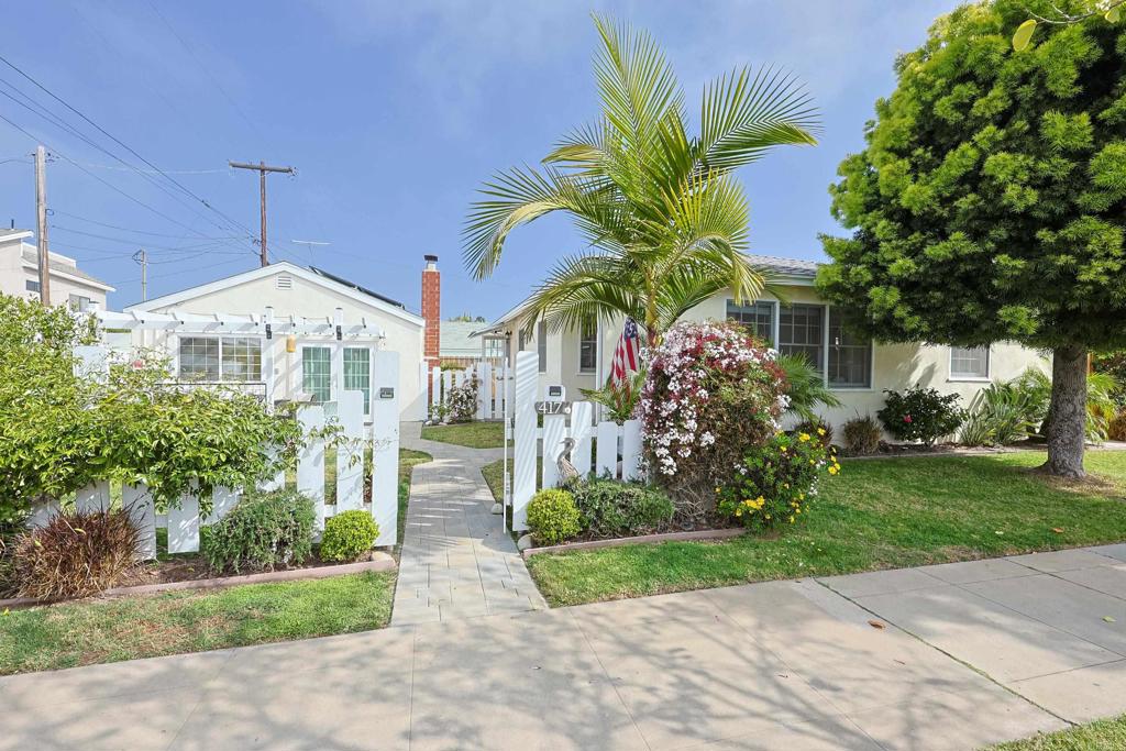 417 5th Street Coronado, CA 92118 - Photo 41 of 46 a front view of a house with a yard and potted plants