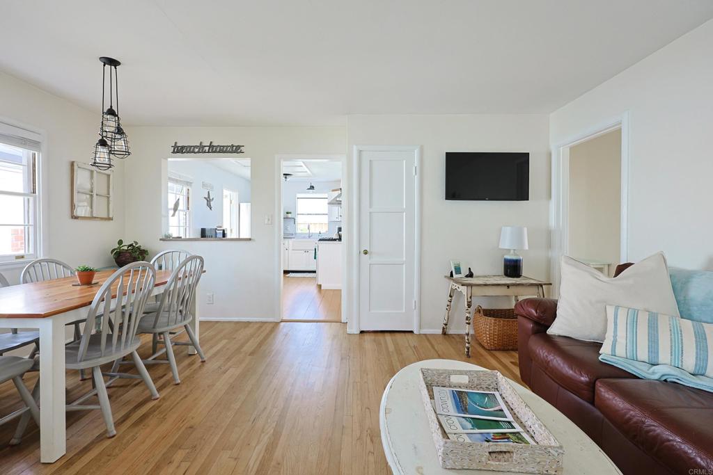 417 5th Street Coronado, CA 92118 - Photo 7 of 46 a living room with furniture a flat screen tv and wooden floor