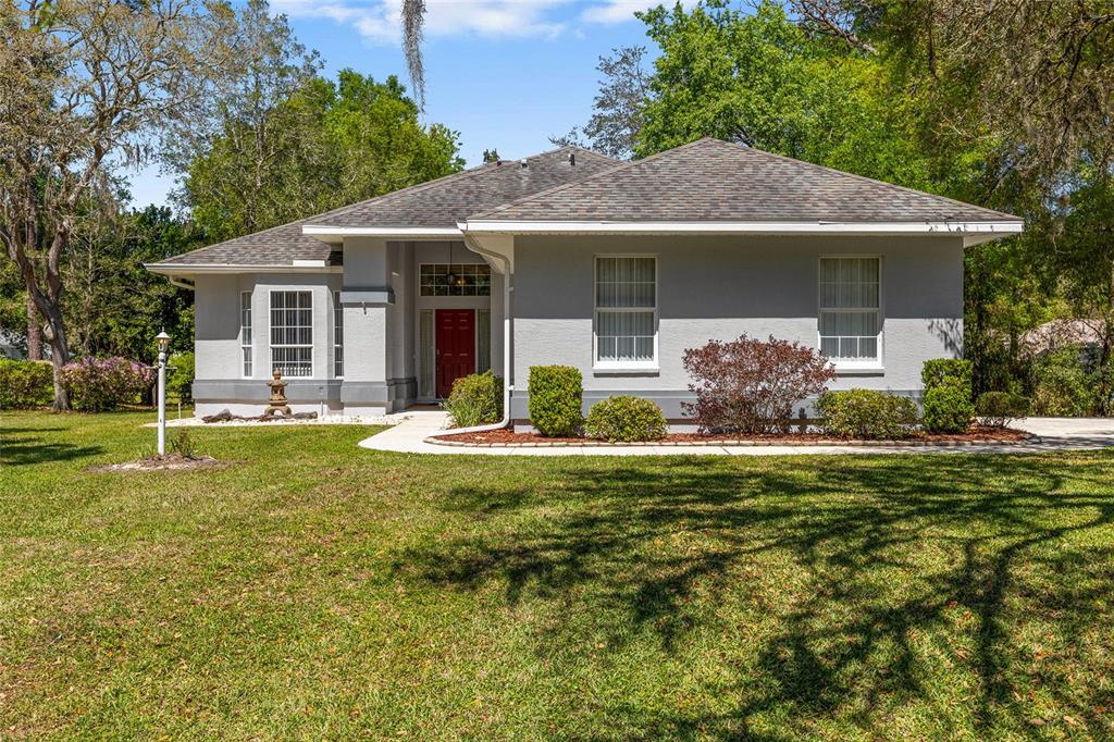 9738 Southwest 195th Circle Dunnellon, FL 34432 - Photo 1 of 1 a house view with swimming pool and garden