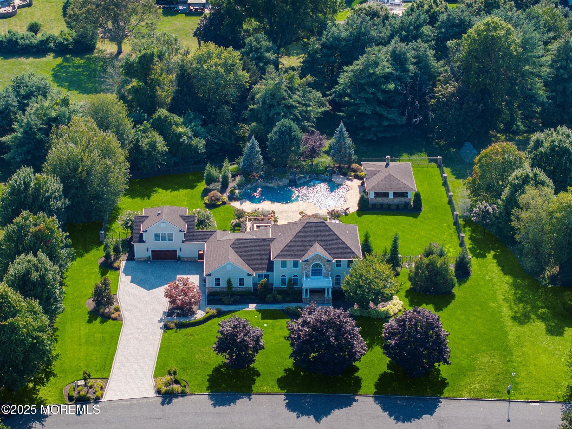 an aerial view of a house with a garden and swimming pool