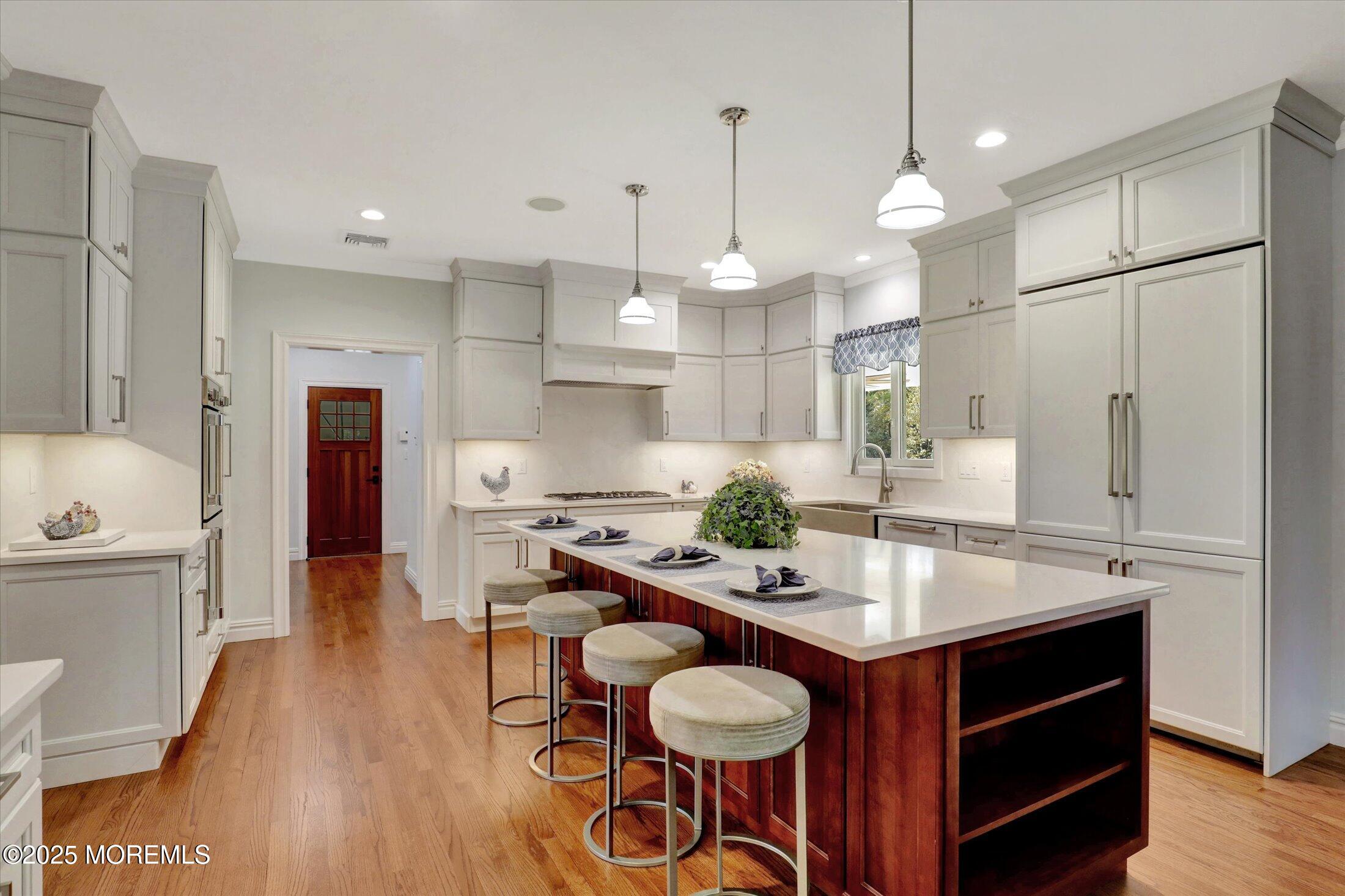 10 Yellow Brook Road Holmdel, NJ 07733 - Photo 13 of 64 a kitchen with granite countertop a table chairs stove and wooden floor