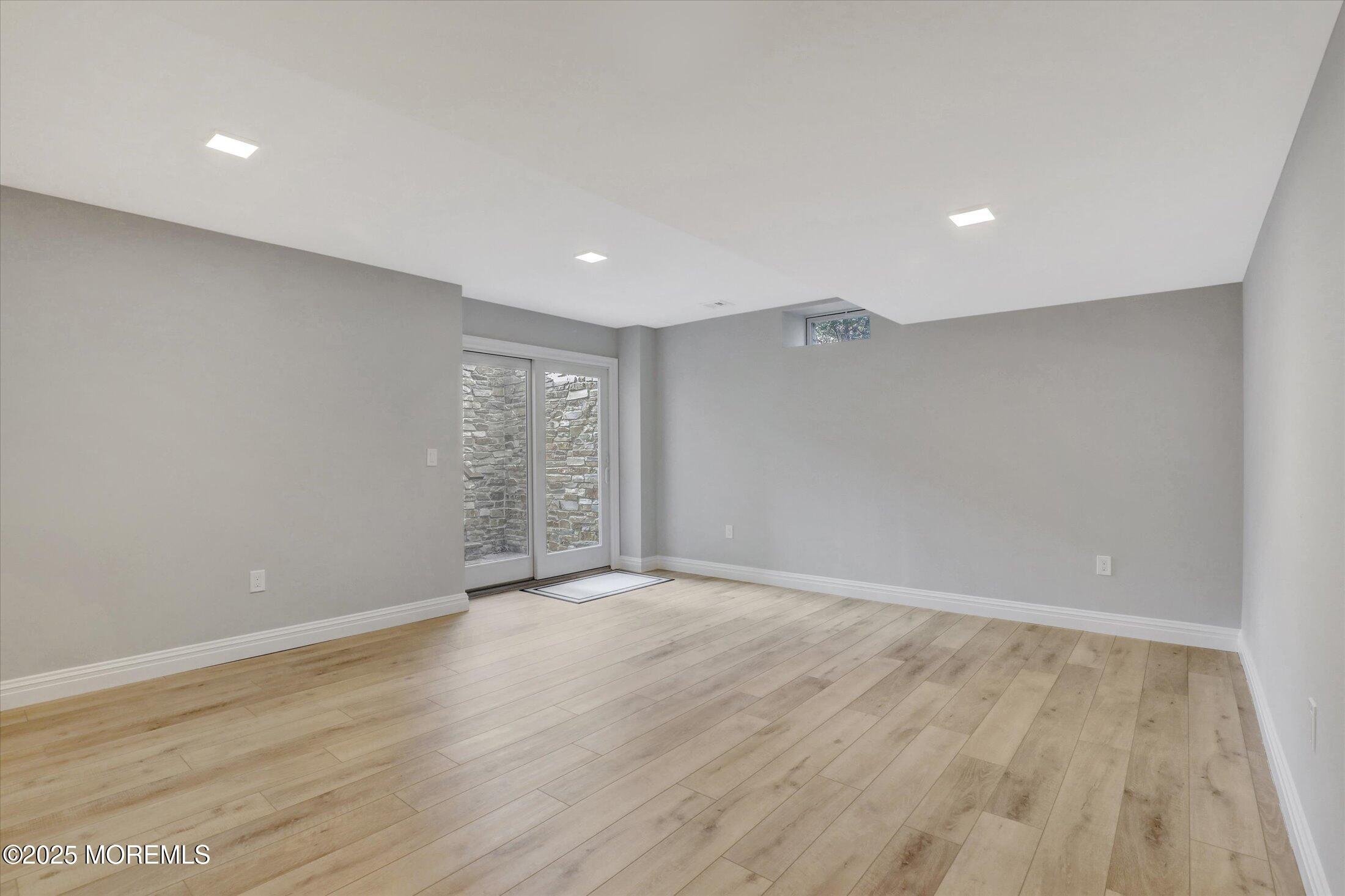10 Yellow Brook Road Holmdel, NJ 07733 - Photo 40 of 64 a view of an empty room with wooden floor and a window