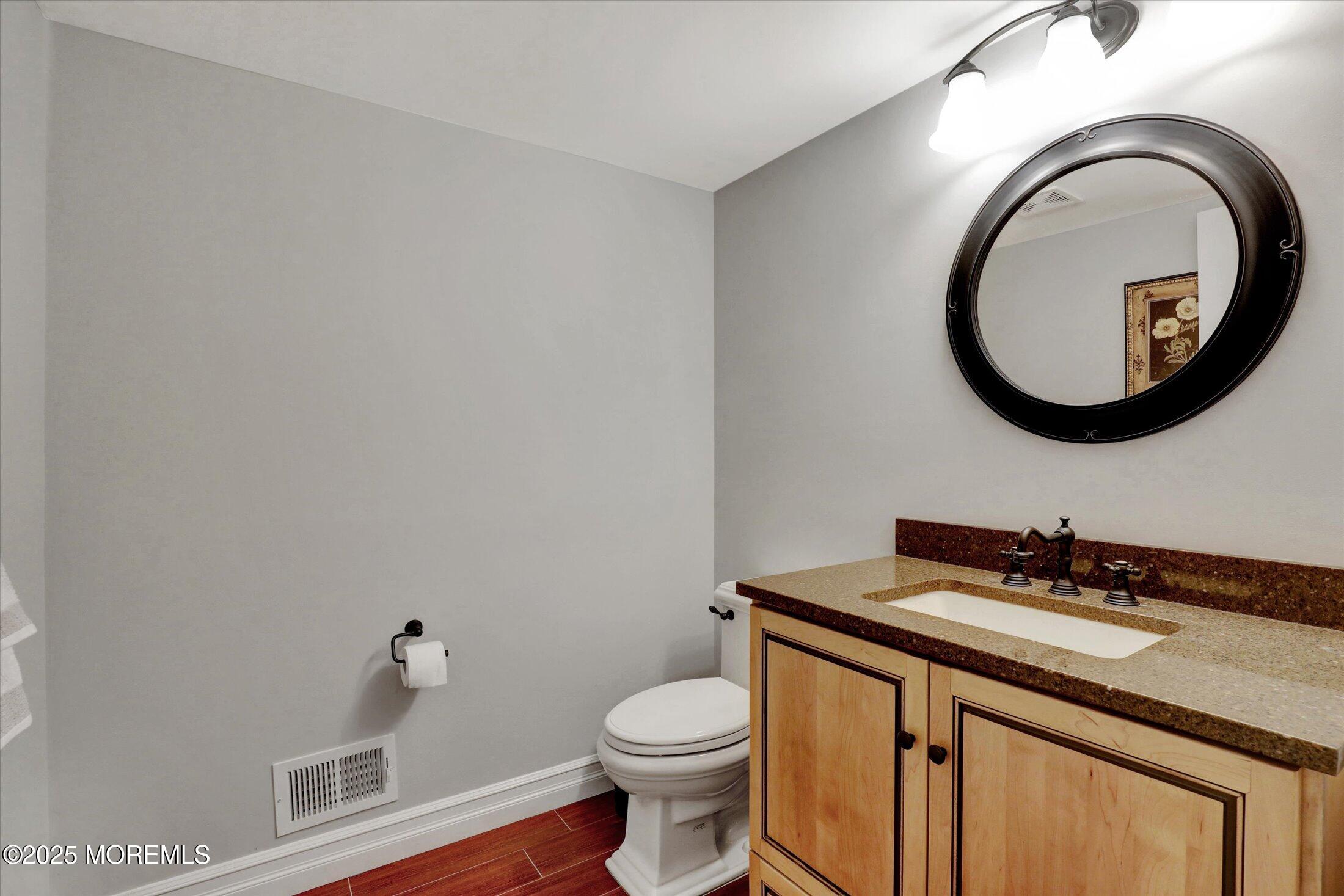 10 Yellow Brook Road Holmdel, NJ 07733 - Photo 42 of 64 a bathroom with a toilet a sink and a mirror