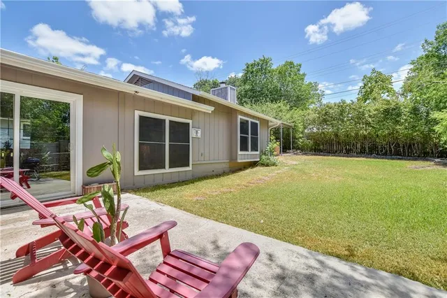 a house view with a sitting space garden and patio