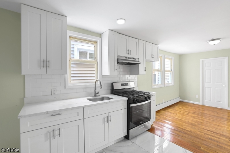 406 South 15th Street Newark, NJ 07103 - Photo 13 of 32 a kitchen with stainless steel appliances granite countertop a sink stove and cabinets